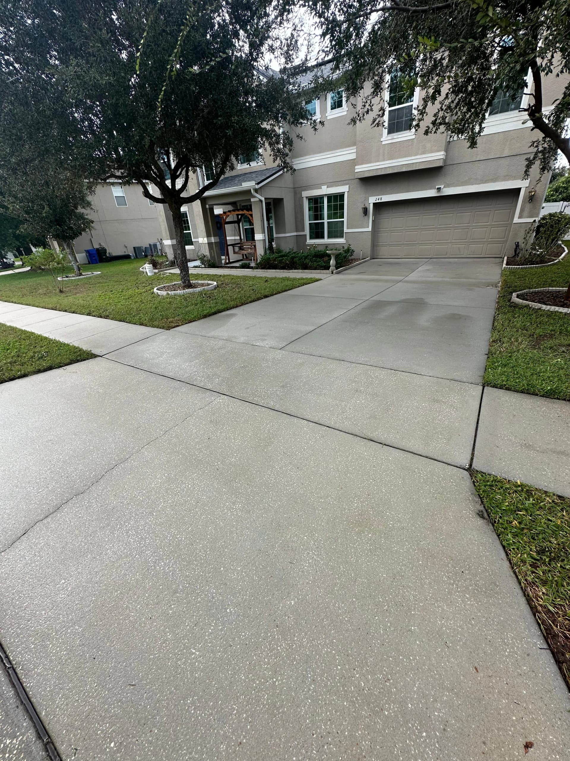 Concrete driveway and sidewalk after pressure washing