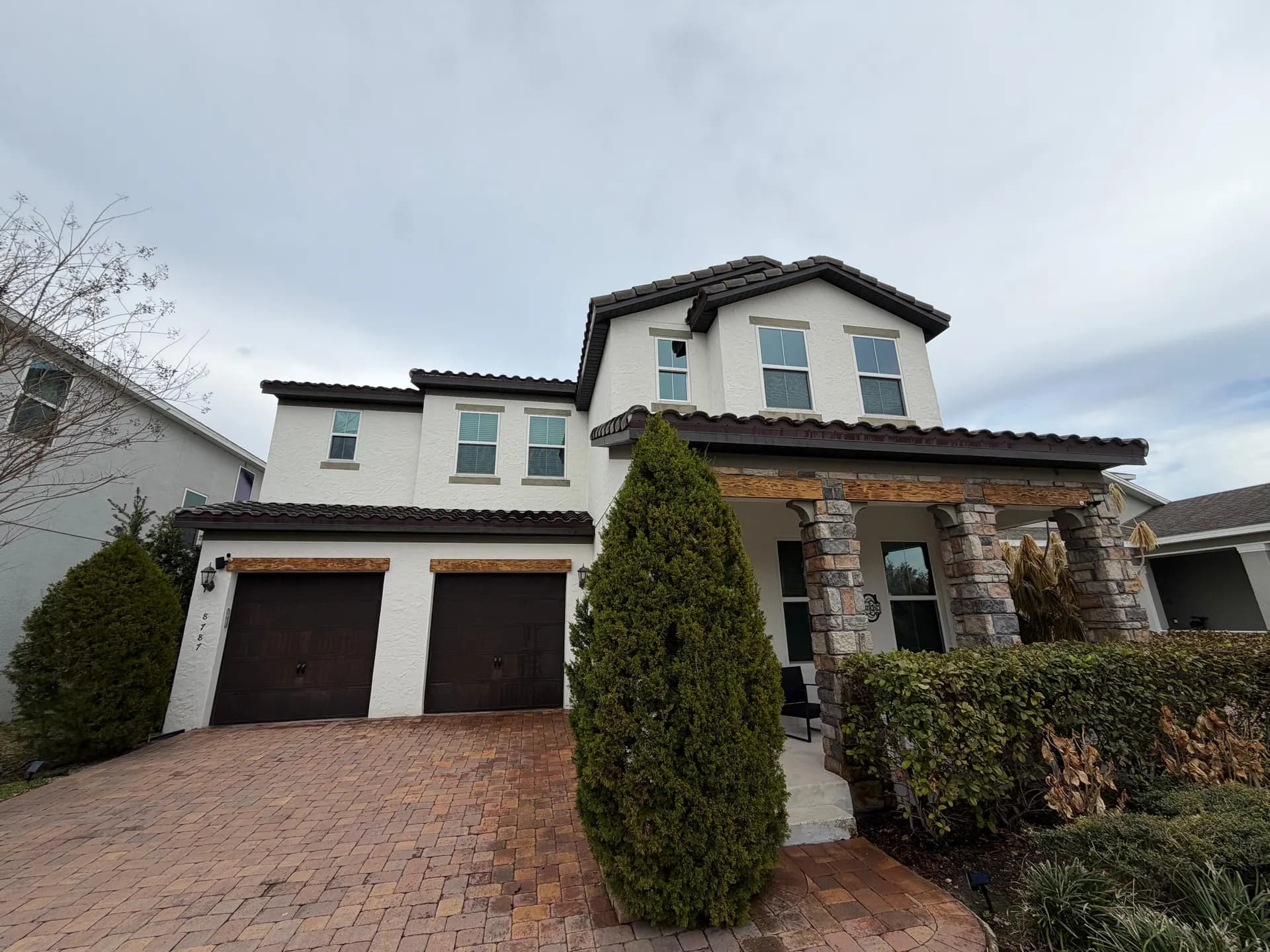 Two-story home with clean gutters along the roofline
