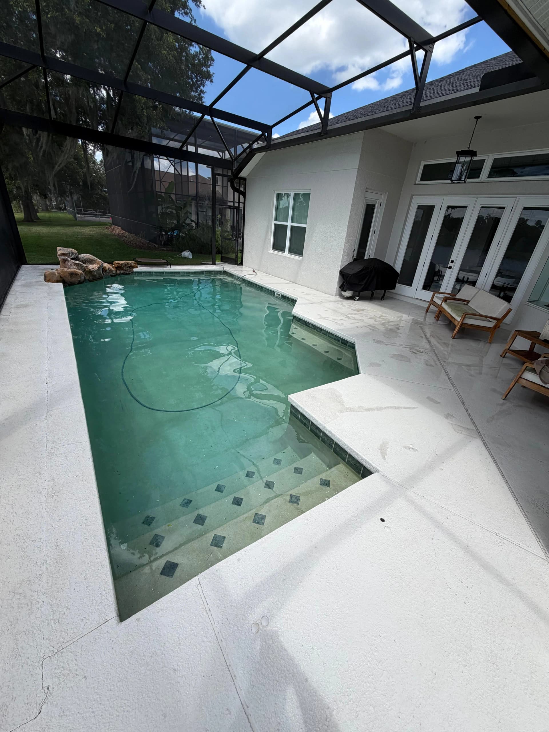 White pool deck and screen enclosure after cleaning